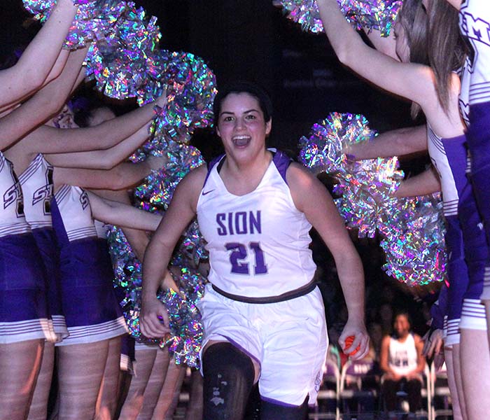 Before the game against St. Teresa’s Academy Feb. 21, senior captain Molly Wagner runs through the tunnel of cheerleaders as they announce the starters. The seniors celebrated Senior Night before the game as it was the last home game of the season.