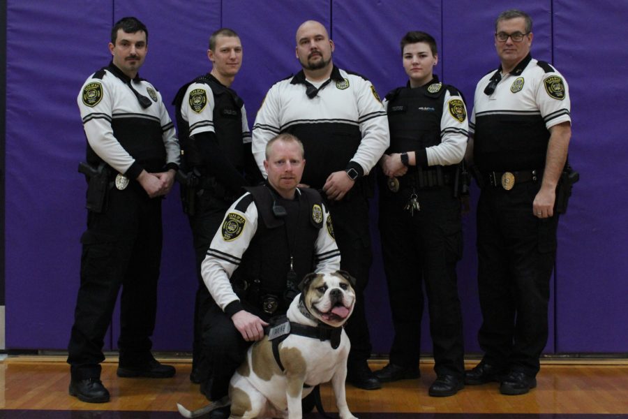 Cpl. Federico Amigoni, Ofc. Aaron Calovich, Chief Charles S. Bell; Sgt kevin B. McNiese, Ofc. Ashley Tedford, and Cpl. William Kelly, with the TAPSKC mascot K9 Rugar-the-Watchdog are the full-time officers that can be spotted on campus.