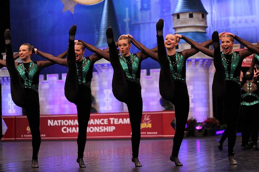 Seniors Megan Broomfield, Kristen Rogge, Chandler Rawson and Emily Kocca, with junior Libby Slaymaker preform the team's kick routine at Nationals Feb. 2. 