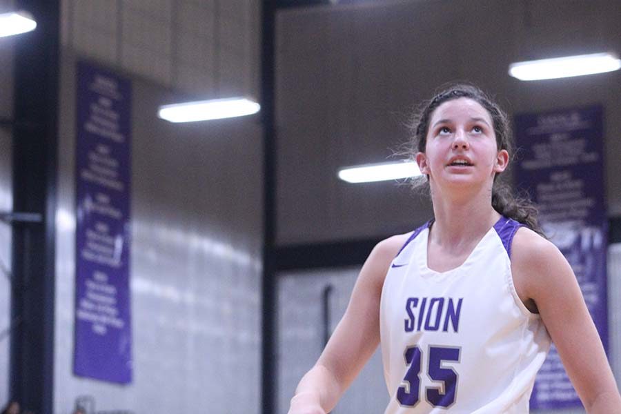 Sophomore Shannon Karlin watches the net and waits to get the ball back after a shot at the net. 