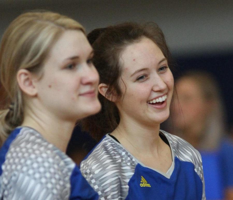 Before game time, junior Liz Jacobs recalls a play from a past game with her teammate, Staley junior Aly Mihlfield.