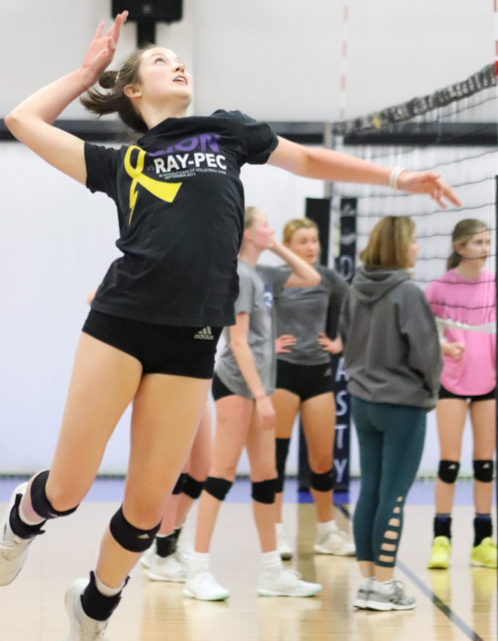 During practice, junior Liz Jacobs hits at her Dynasty teammates on the opposing side of the net during a drill.