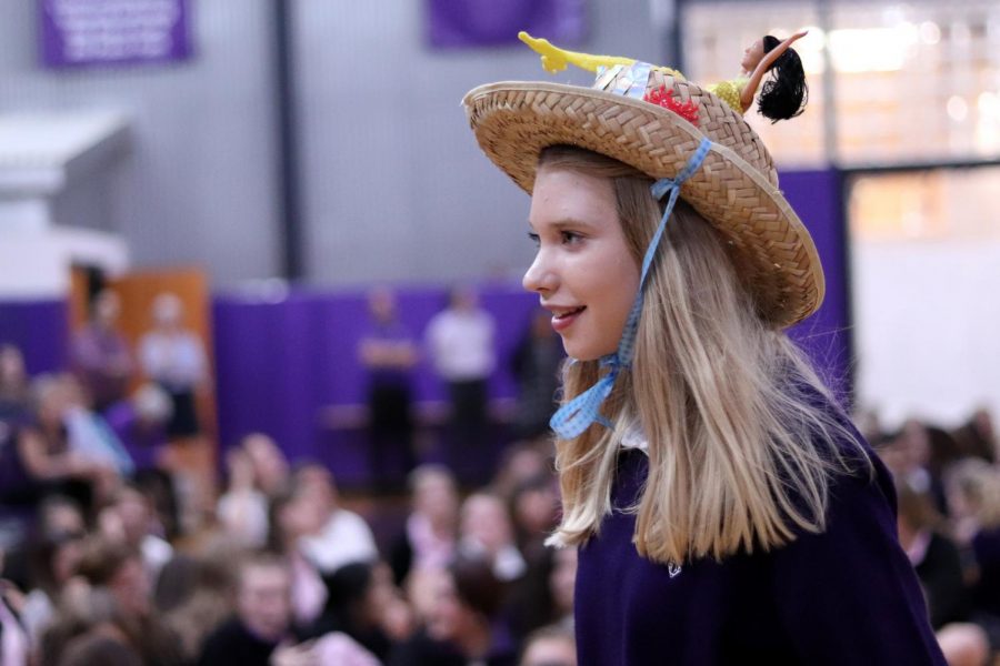 As she walks toward the edge of the gym, freshman Ella Abiecunas sports her senior-made straw beanie.