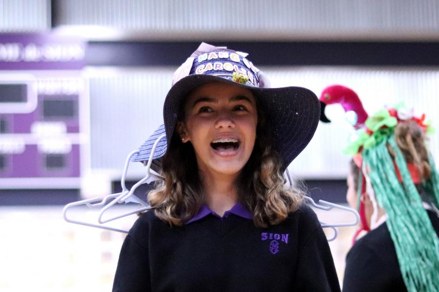 Carrying on the classic tradition, freshman Carolina O'Byrne sports her “hang loose” beanie complete with falling hangers. 
