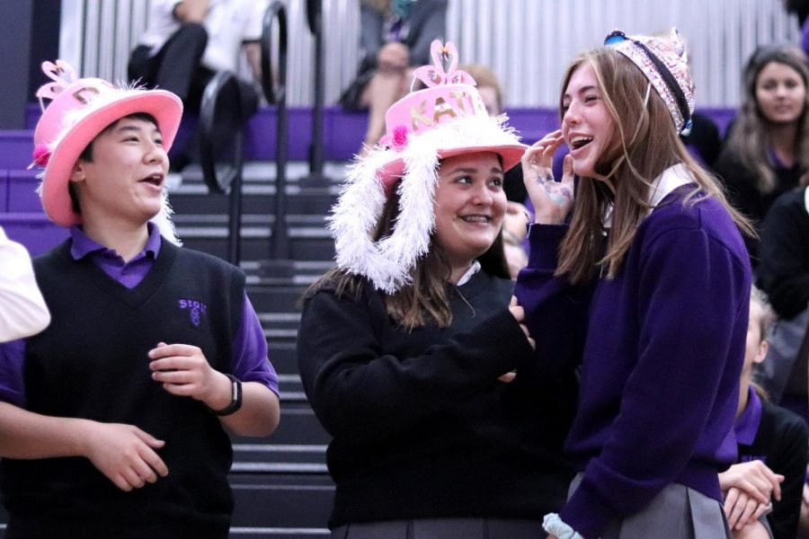 Freshmen Dori Sandritter, Katherine Porch and Grace Gaither react to their new pink accessories.