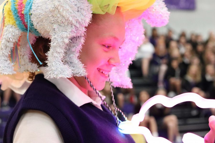 With impressed gasps coming from the crowd, freshman Makayla Hebert lights up her unicorn necklace that accompanied her beanie. 