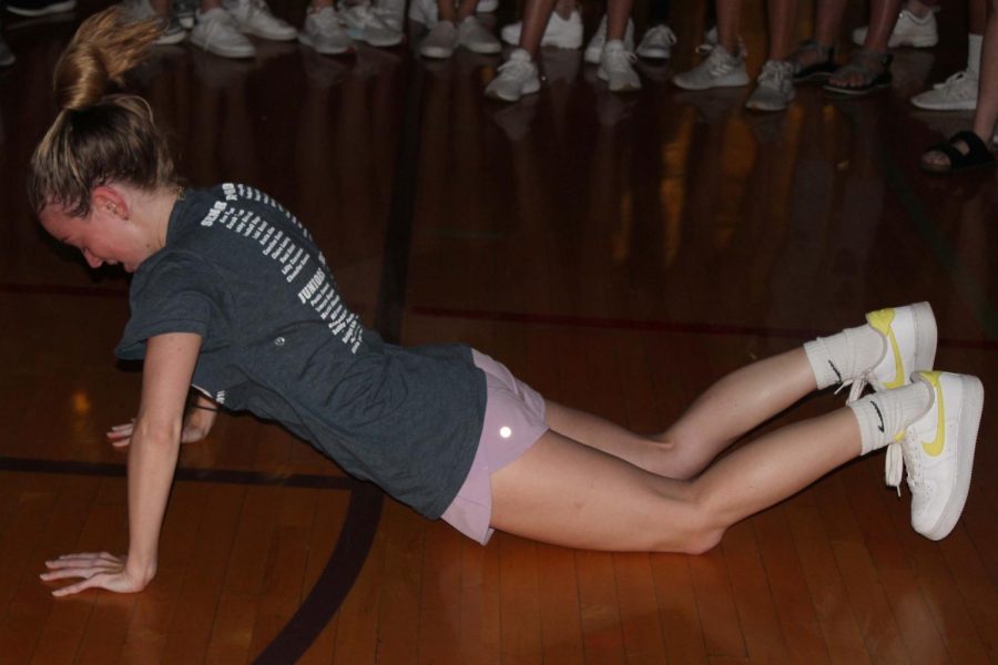 As everyone gathers in a circle, sophomore Tess Tappan shows off her worm dance move.