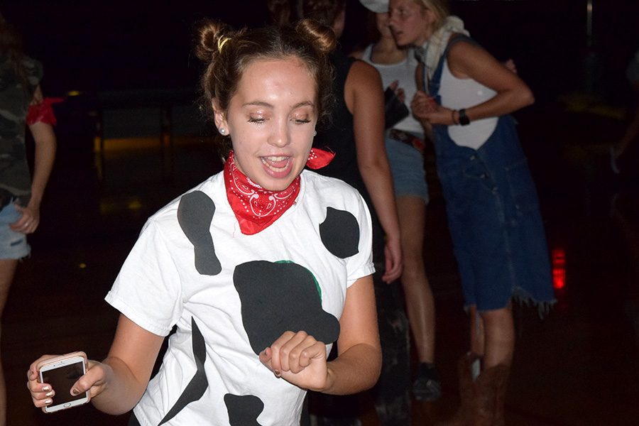 Senior Bridget Schumm dances in a cow-costume for the farm-themed Fall Dance Sept. 9, 2017. 