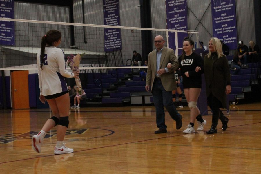 As senior Abby Gahagan's name is called, she entered the gym to receive flowers alongside her parents at volleyball's Senior Night Oct. 10. At Thursday night's game against Raymore-Peculiar High School, senior players were recognized and honored. 