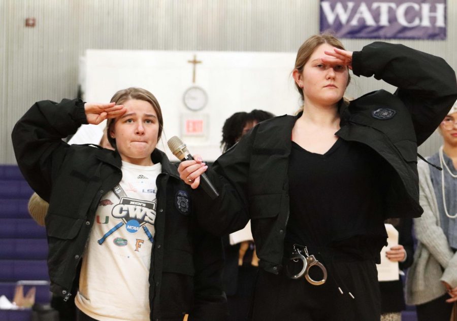 During the annual Food For Thought skits, seniors Avery Jones and Maddy Anstoetter impersonate the Taps officers Oct. 31. Each class participates in a skit to raise excitement about the upcoming canned food drive that benefits Redemptorist.