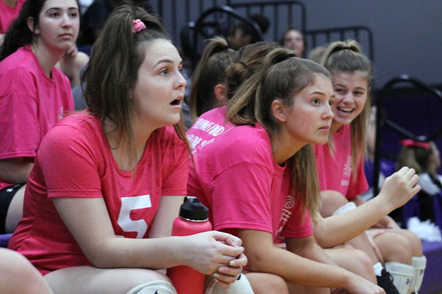 Seniors Abby Gahagan and Katie Fitzgerald observe the game from the bench at the annual Dig Pink volleyball game Oct. 3. The annual game in support of breast cancer awareness raised $1,300 for the Susan G. Komen foundation. 