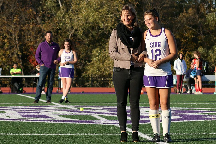 Senior Sam Shively is honored alongside her mother for field hockey's Senior Night Oct. 22. The field hockey team lost 3-1 to Pembroke Hill. 