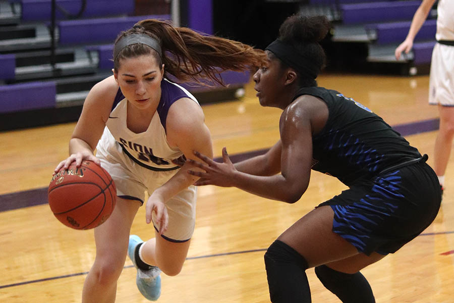 Junior Gabby Gaither drives the ball towards the basket to shoot in the second quarter of the game against Lincoln Prep High School Feb. 18.