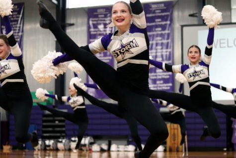 Junior Kaitlyn Quinn leaps to the ground during dance team's performance at the pep rally Feb. 27.