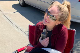 Senior Madi Brown watches the parade in her driveway Saturday April 18. 