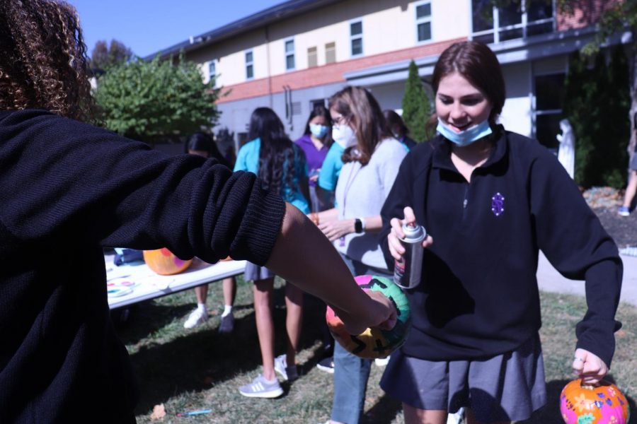 Seniors Mary Elizabeth Amiri and Gabby Gaither paint their pumpkin outside during study hall on Oct. 13.