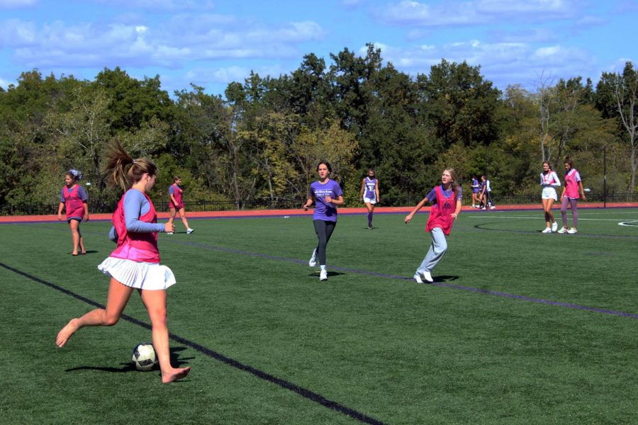 Students play a half-field soccer scrimmage on the turf during Field Day on Oct. 1.