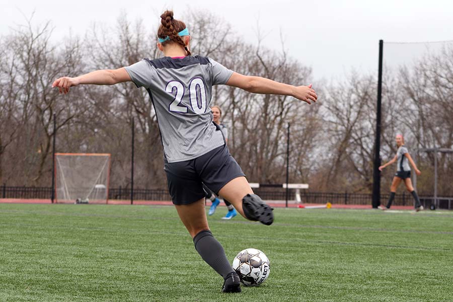 Freshman Jane Lehmann kicks the ball up the field to her teammates March 23. 