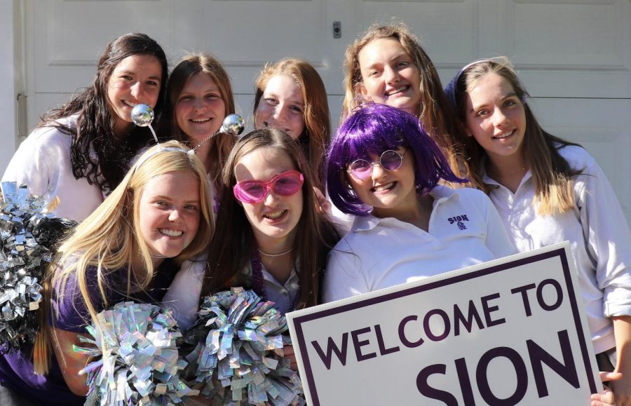 Seniors Shannon Karlin, Madeline Hammett, Sharon Kramschuster, Mason Lewis, Maggie McKinney, Sophia Allen, Olivia Shively and Avery Brundige pose for a picture in their uniforms on May. 21.