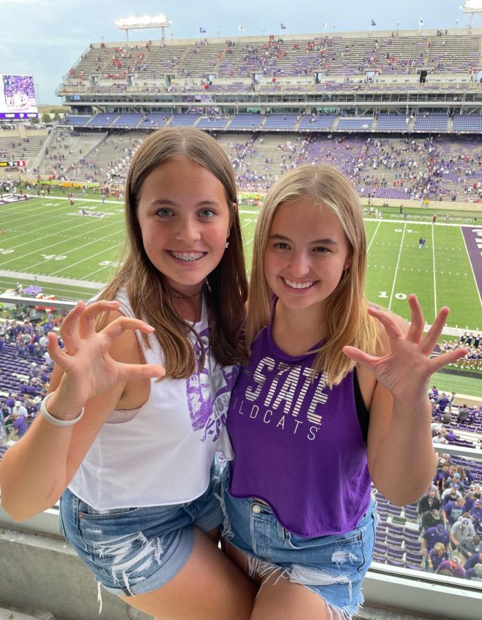 Freshman Charlotte Zender and Senior Liv Zender pose for the camera while at a Kansas State University football game.  