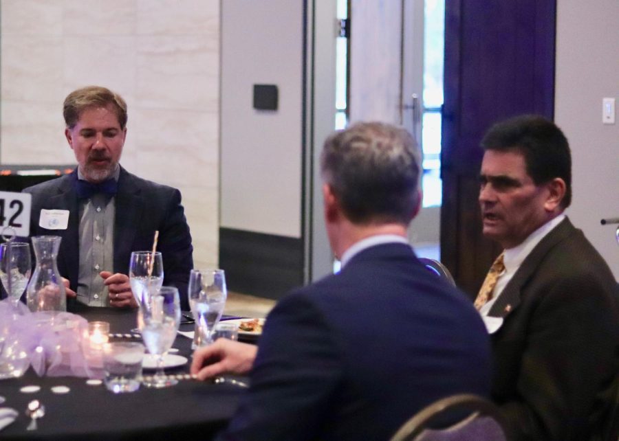 Dads enjoy dinner among one another. 