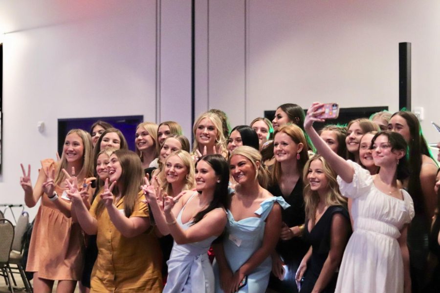 The senior class poses for a photo before honoring the tradition of singing to their dads.  