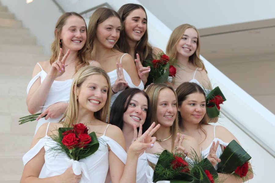 The Class of 2022 poses for pictures after their graduation ceremony at the Kauffman Center for the Performing Arts.