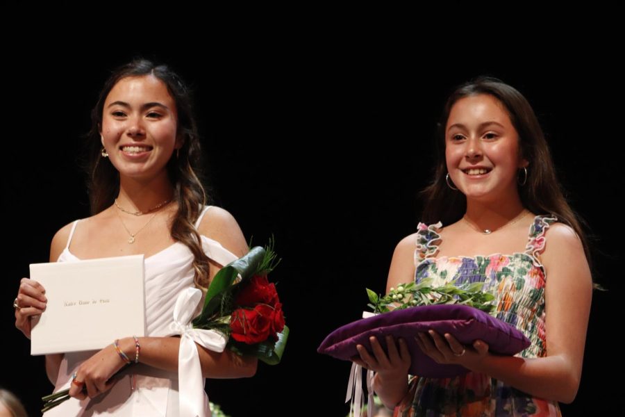 Sofia Aguayo '22 stands with her sister and crown bearer, Gianna Aguayo, after receiving her diploma. 