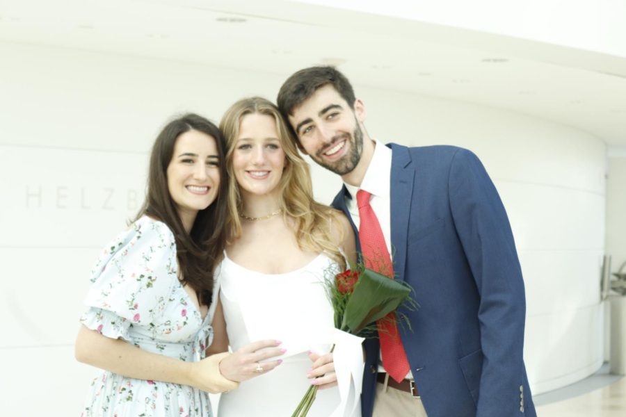 Ava Albracht '22 poses for a photo with family after the ceremony. 