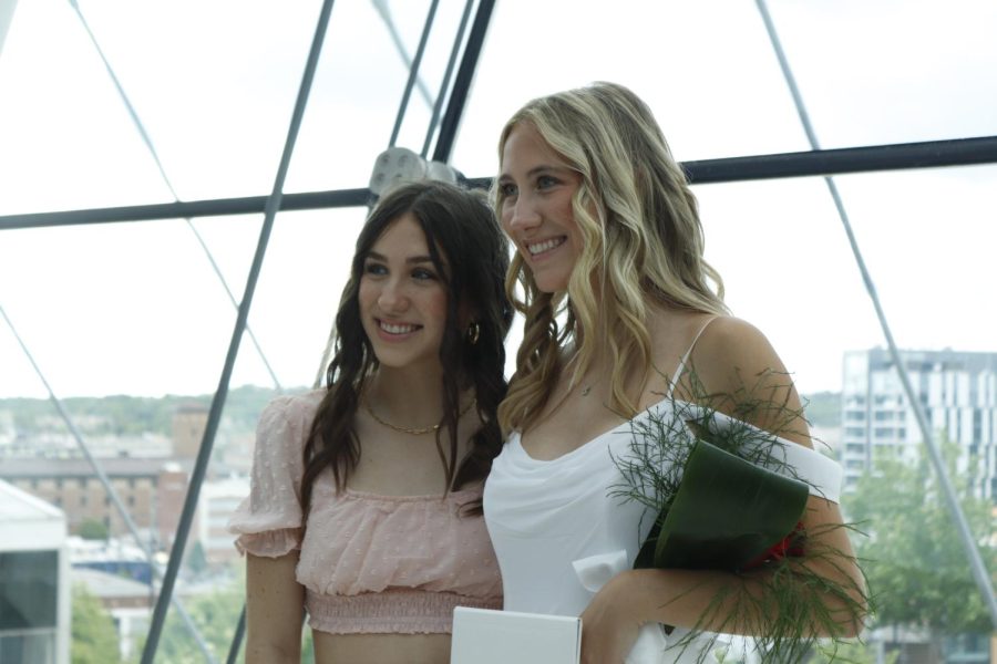 Sophia McClure takes a photo with her sister, rising sophomore Stella McClure, after the ceremony.