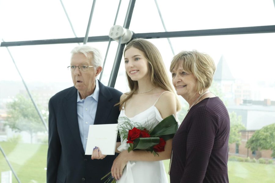 Lauren Shaw '22 poses for a photo with family after the ceremony. 