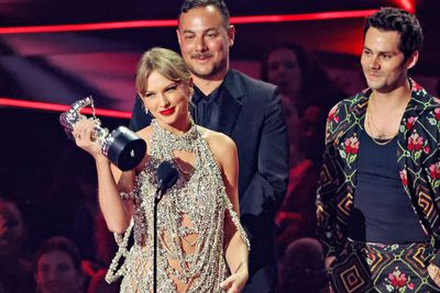 Taylor Swift poses with her Moonman statuette after winning Video of the Year for "All Too Well: The Short Film." The project also won the categories for Best Long Form Video and Best Direction, making Swift the most awarded artist of the night, as well as the fourth-most decorated artist in the show's history.