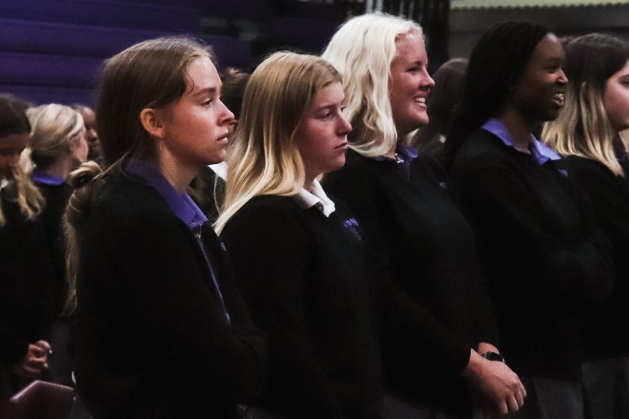 Juniors (left to right) Georgia Gomez, Hannah Lange, Caroline Hammett and Kosi Okuagu laugh together during the first all school mass. 