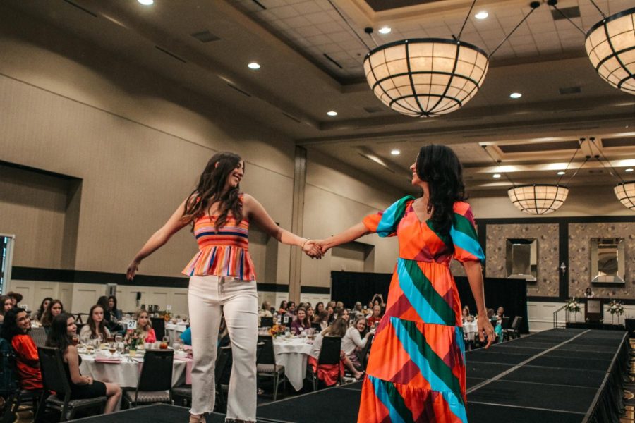 Senior Sophia Boulware and her mom Sasha Boulware share a loving gaze at the end of the runway.