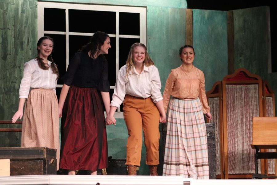 Hand-in-hand, the four March sisters, played by freshman Arle McCallon, junior Noelle Bertrand and seniors Addie Hiestand and Caroline O'Byrne, pictured left to right, perform "Our Finest Dreams."