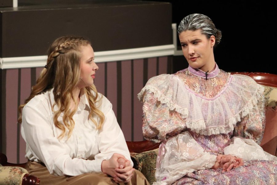 With a stern look on her face, Aunt March, played by senior Caroline Dold, shares her perspective on the important aspects of womanhood with senior Addie Hiestand.