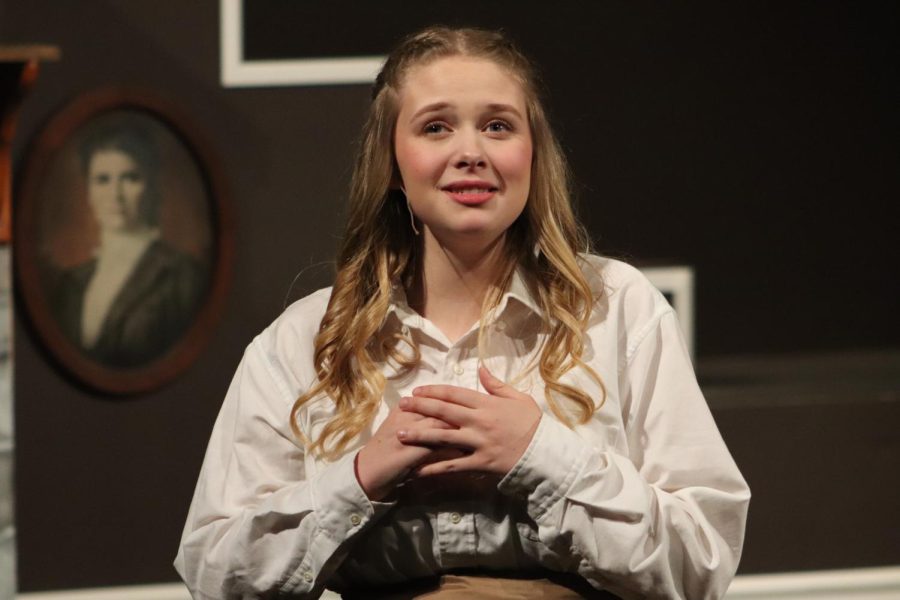 Looking out at the audience, senior Addie Hiestand sings "Astonishing."