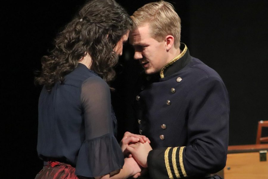 Embracing one another, junior Noelle Bertrand and Whitefield Academy junior Henry Schulewitz perform the proposal scene between Meg March and John Brooke.