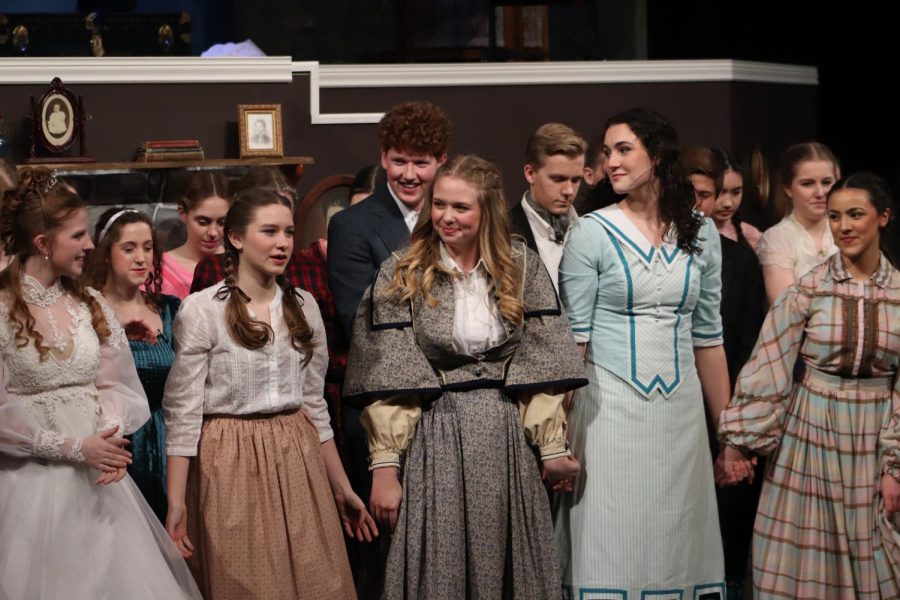 Looking at one another with sad smiles, junior Claire Boma, freshman Arle McCallon, senior Addie Hiestand, junior Noelle Bertrand and senior Carolina O'Byrne, pictured left to right, take their final bow of the show.