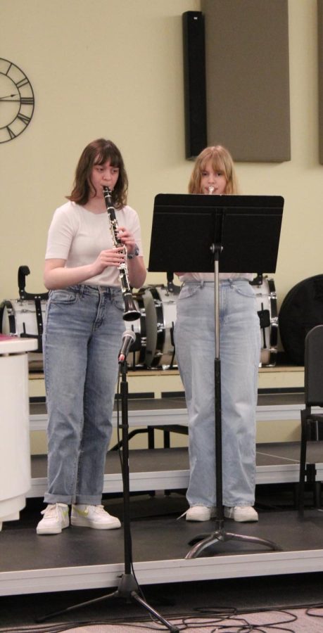 Sophomore Amelia Bedel plays the Clarinet with Sophie Heidelman who plays the trumpet as they perform "Yesterday" by The Beatles . 