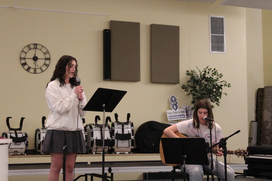 Senior Caroline Dold plays guitar and sings with junior Noelle Bertrand to perform "Hallelujah" by Leonard Cohen. 