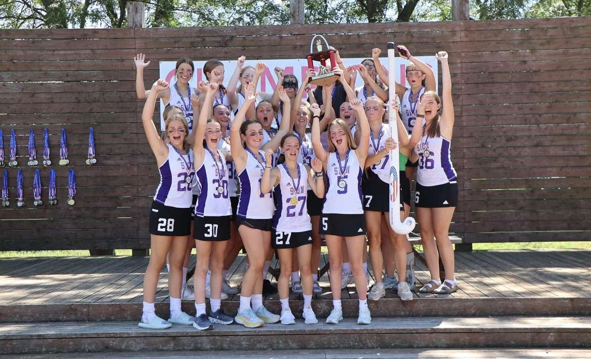 Yelling out in excitement, the field hockey team stands together to take a photo on Sep. 2 after winning the gateway tournament for the first time in 15 years. “It was one of my best field hockey memories ever, " Greta Martin said. “We got on the bus after the game and started screaming “We are the champions” and took super cute pictures with the trophy and our medal.” 