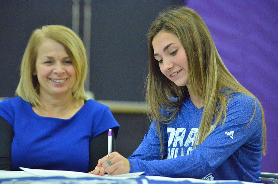 While her mother Pam Kearney looks on, senior Meghan Kearney officially signs to run track and cross country with Drake University