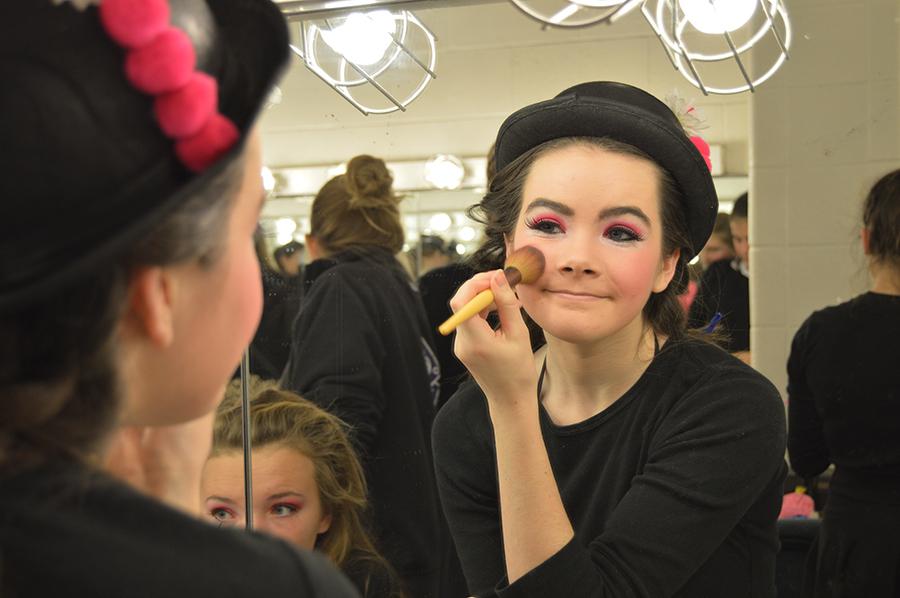 Sophomore Clare Carey prepares in the dressing room before going on stage as a Who. Seussical was Carey's first musical at Sion. 