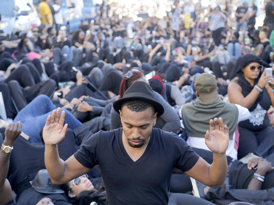 Jamey Wentling, along with other protesters, in front of Manns Chinese Theatre on Hollywood Boulevard on Saturday, Dec. 6, 2014, in Los Angeles. A group calling itself Black Out Hollywood planned the protest against police violence, and the march ended where police shot and killed a knife-wielding man on Friday night.