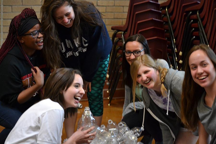 Sophomores Natalie Moussa, Bilha Kahindi, Esobel Moore, Honor Schleicher and sophomore Hannah Hawver pose in front of plastic water bottles.
