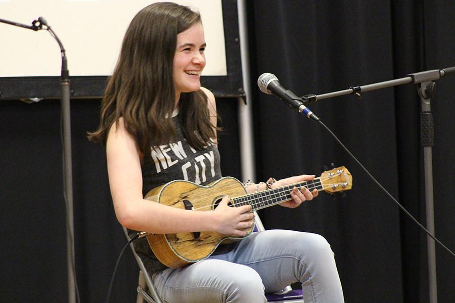 Sophomore Clare Carey laughs before performing "I am Not a Robot."