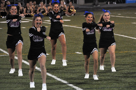 Sophomores Cat Wilkerson, Gabi Atchity, Maddi Clark,  junior Taylor Spies and senior Kaitlin Wagner dance during the cheer team's performance at Rockburst High School Sept. 4. 