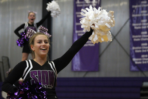 Sophomore Cat Wilkerson performs with the cheer team during the pep assembly Sept. 4. 