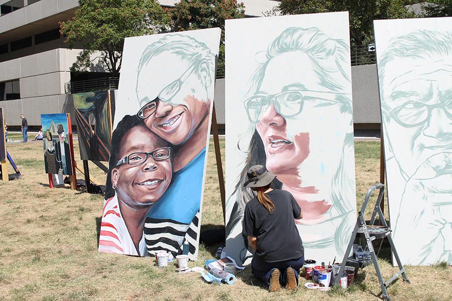 Two of the five giant poster boards take up a spot on the grass. These creations took the entire weekend to fully complete.